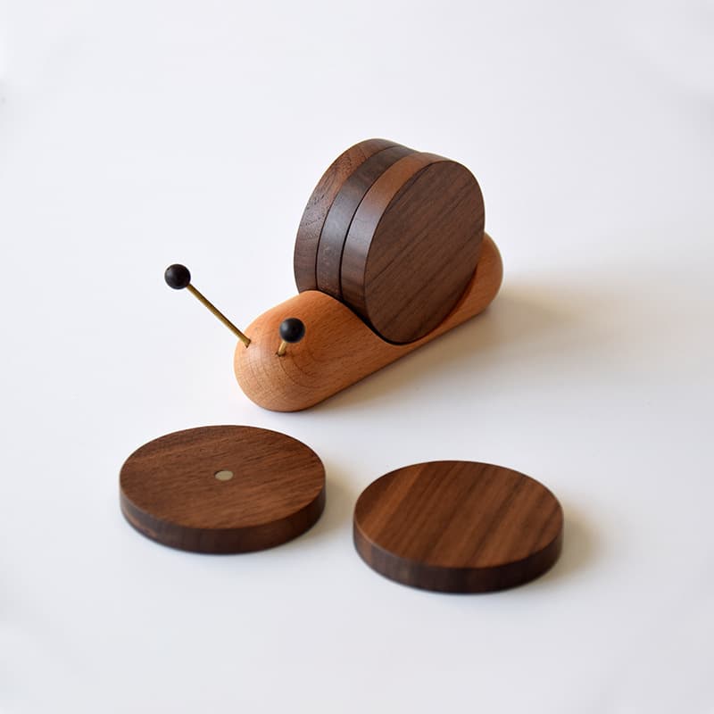 Snail shaped wooden coasters set for drinks